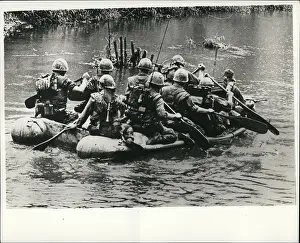 Cong: Paddle patrol on a river, Vietnam War