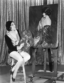 Accomplishment: Painter admiring her creation