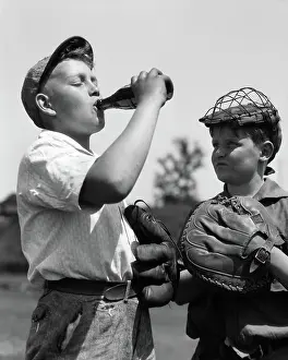 Mitt: Pair of boys wearing baseball gloves one with