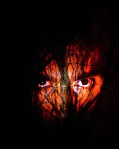 Spook: Pair of Sinister Threatening Male Eyes Behind