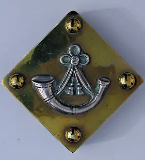 Paperweight: Paperweight with a silver badge