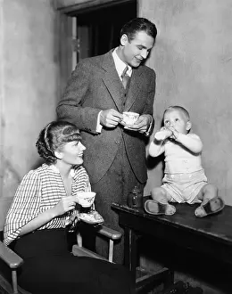 Paternal: Parents with baby drinking from bottle
