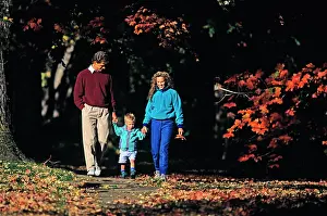 Wal004: Parents and Son Walking on Sidewalk in Autumn