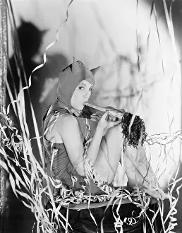 Carnivals: A party devil, a young woman blows her own horn