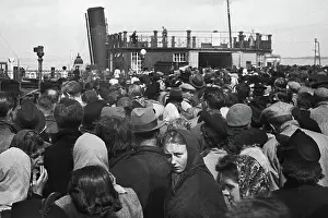 Anxiously: Passengers about to board a ferry