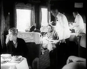 Passengers Sitting in the Dining Car of a Train