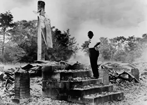 Discourage: Pastor H.C. McClain looking over the burned ?