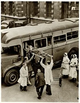 Barts: Patient on stretcher lifted onto evacuation coach 1939