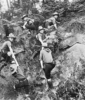 Fortnights: Patrol of boy scouts making its way across difficult country