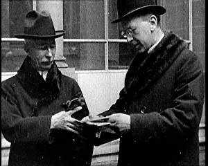 British Pathé Ltd: Peace Delegates Reading Notes As They Leave