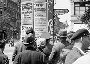 Monarchist: Pedestrians while looking at an election poster
