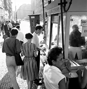 Cobble: Pedestrians - shadows - cobble stone - phone booth