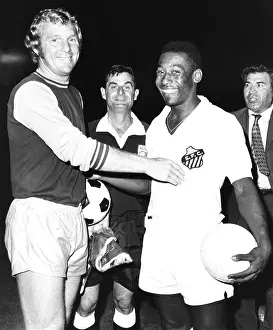 Three Quarters: Pele of Santos of Brazil with Bobby Moore, the