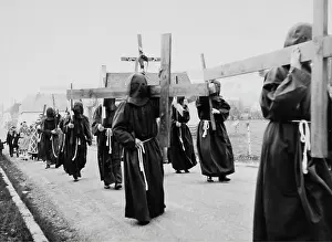 Mumming: Penitents wearing hoods and crosses in Easter procession