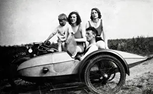 Suave: Four people on a 1929 Ariel motorcycle & sidecar