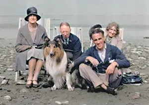 Pebbly: Four people on beach with collie dog
