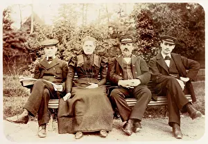 Peaked: Four people on a bench in a garden