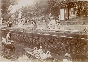 Punt: People boating on a canal, with spectators above them