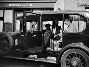 Flasks: Four people in a car outside a Post Office