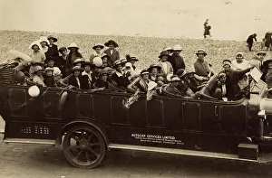 Pebbly: People in a charabanc at the seaside