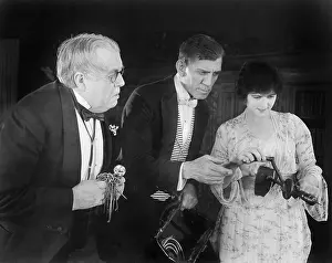 Strive: Three people checking out a manual drill