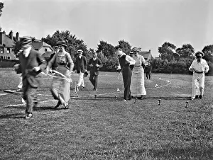 Blindfold: People at a comic sports event in a field