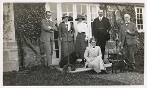 Grumpy: Six people with two dogs in a garden