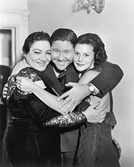40 45: Three people embracing and laughing
