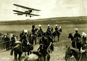 Alfieri: People in a field looking up at a biplane