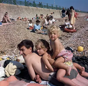Pebbly: People on holiday on a pebbly beach