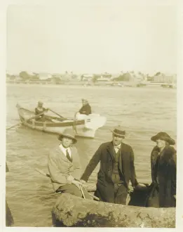 Sepia Images: Three people in inflatable boat, Middle East