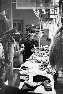 Bric A Brac: People looking at items on a fundraising stall