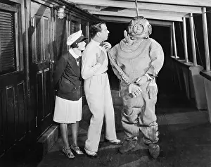 Startle: Two people looking in shock at a diver in a divers suit