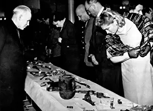 Tormented: People looking at torture instruments by which