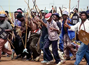 Assegais: People, mainly men, armed with traditional weapons