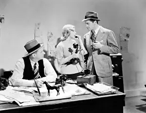 Blonds: People in an office talking on a candle stick telephone