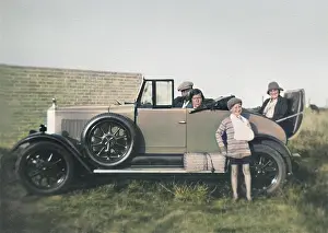 People in open-topped car