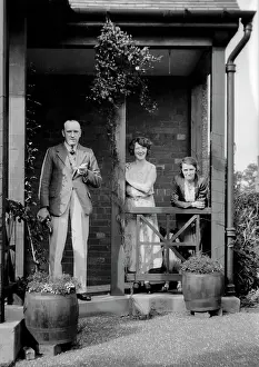 Drainpipe: Three people outside a house