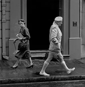 Two people pass each other in a London street