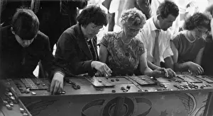 Markers: People play bingo at a fairground stall