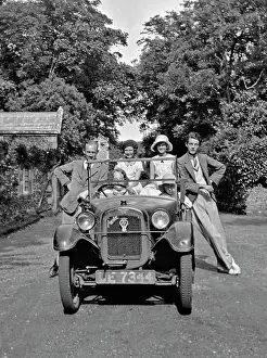Numberplate: People posing with Austin car