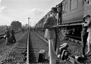 Halted: People on a railway track alongside a train