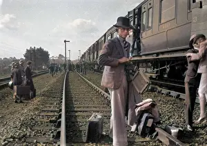 Interrupted: People on a railway track alongside a train
