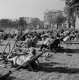 Pigeons: People relax on deck chairs amongst pigeons in Hyde Park