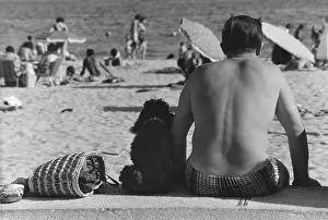 Parasols: People relaxing on a beach