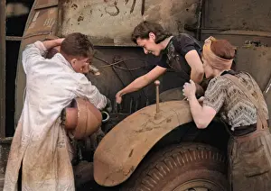 People repairing a vehicle