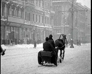 People Riding Mule Drawn Sleds Through Snow