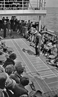 Backward: People on ship's deck playing a game