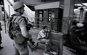 Transkei: Two people sit near a train station, watching