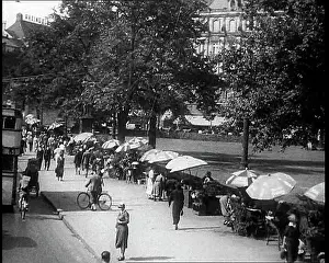Parasols: People Sitting Under Parasols and Walking Down